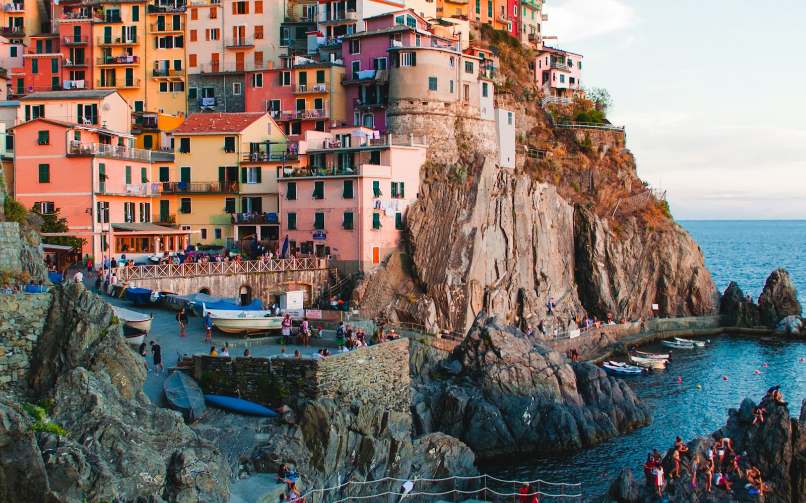 The pastel houses of Manarola glowing at dusk above the Ligurian Sea, Cinque Terre